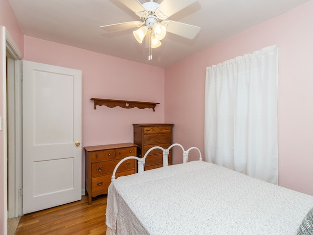 bedroom with ceiling fan and light hardwood / wood-style flooring