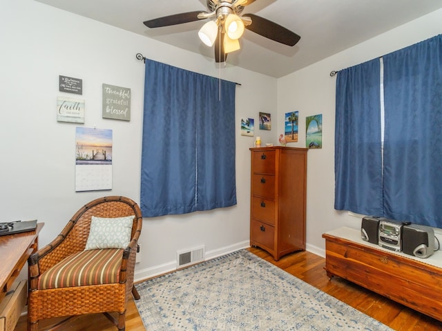 living area with ceiling fan and hardwood / wood-style floors