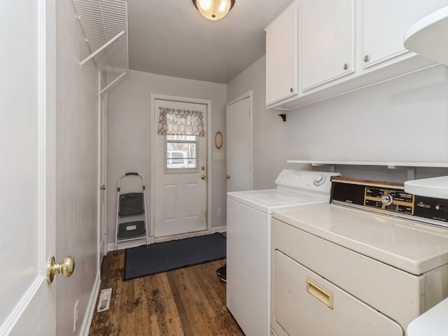 washroom with dark hardwood / wood-style flooring, cabinets, and separate washer and dryer