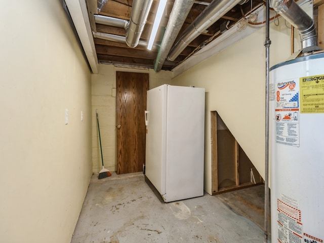 basement featuring white refrigerator and water heater