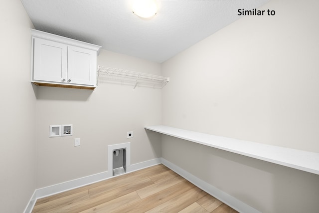 clothes washing area with cabinets, hookup for a washing machine, hookup for an electric dryer, a textured ceiling, and light hardwood / wood-style floors