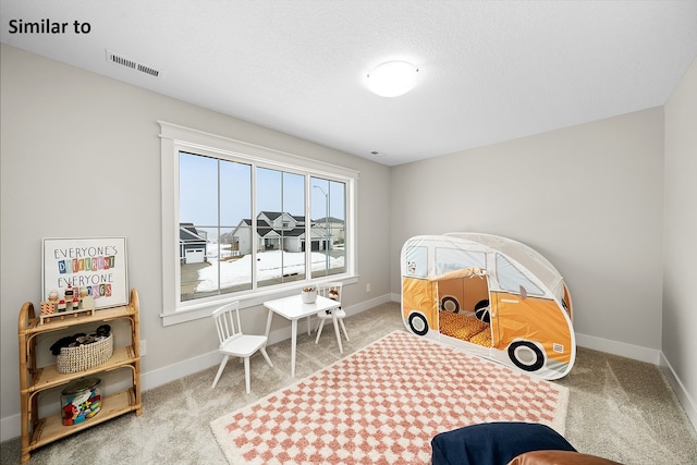 carpeted bedroom featuring a textured ceiling