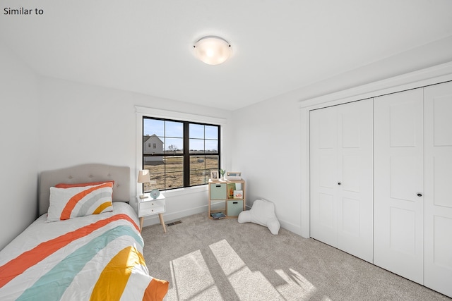 carpeted bedroom with a closet