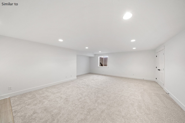 unfurnished room with light colored carpet