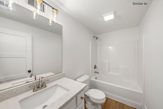 full bathroom with vanity, bathing tub / shower combination, toilet, a textured ceiling, and wood-type flooring