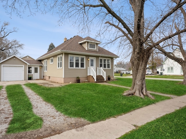 view of front of home featuring a garage, an outbuilding, and a front yard