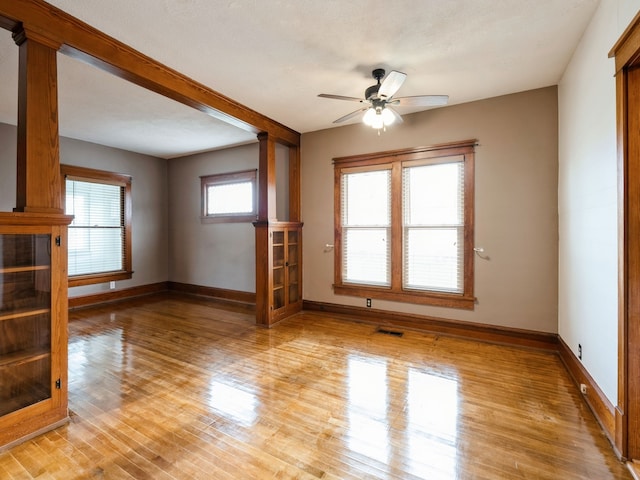 unfurnished living room with a textured ceiling, light hardwood / wood-style floors, and ceiling fan