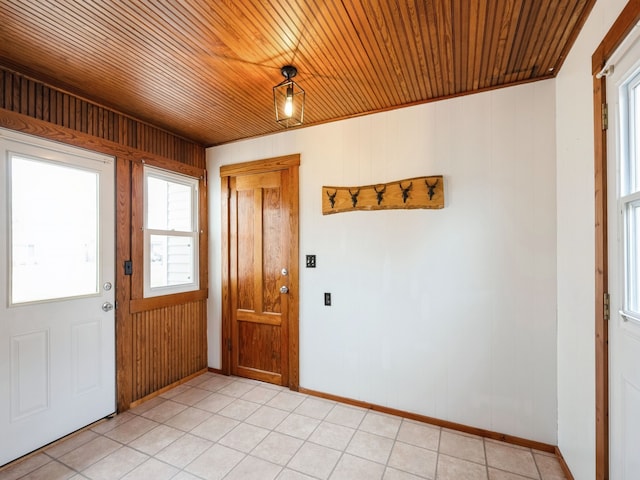 entryway featuring light tile patterned flooring, wooden ceiling, and wooden walls