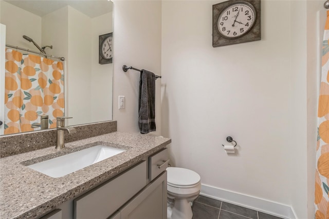 bathroom with vanity, tile patterned flooring, and toilet