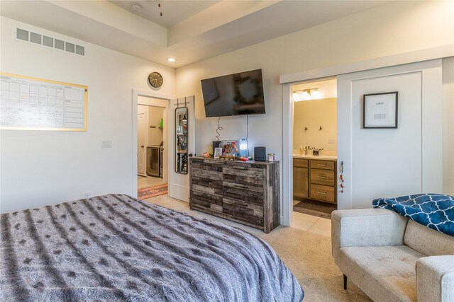 carpeted bedroom featuring ensuite bathroom