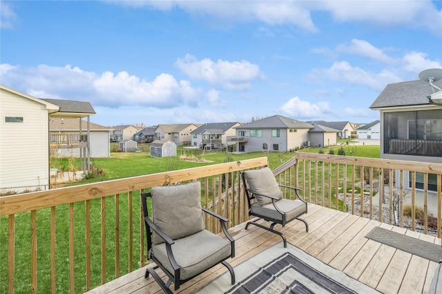 deck featuring a shed and a yard