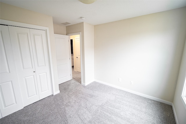 unfurnished bedroom featuring a closet and carpet floors