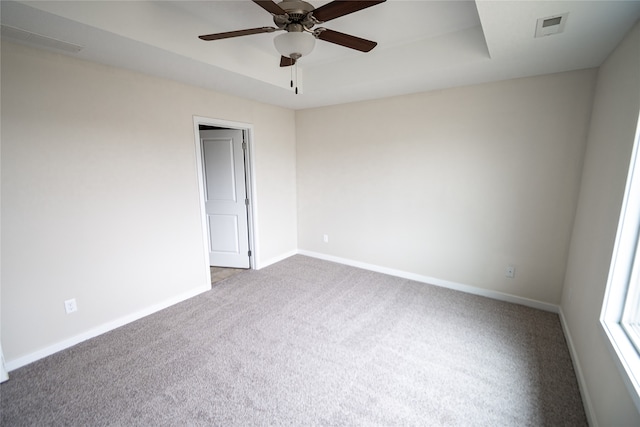 carpeted spare room with ceiling fan