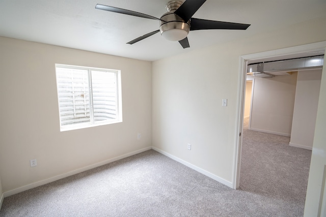 unfurnished bedroom featuring ceiling fan, a closet, and light carpet