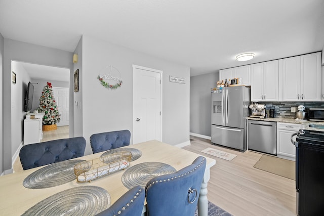 dining space featuring light hardwood / wood-style flooring