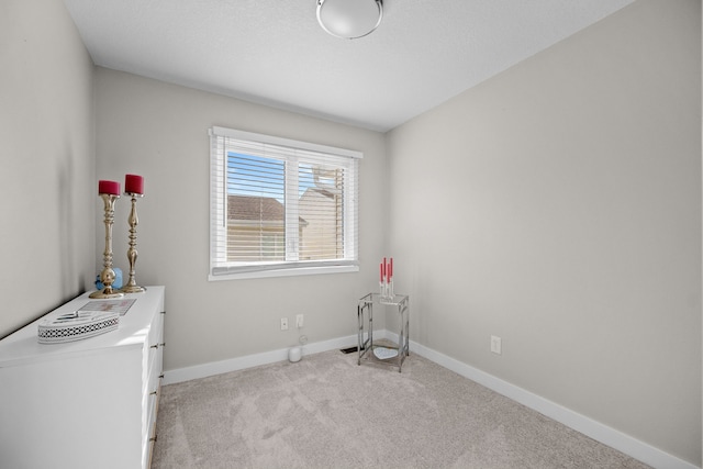 miscellaneous room with light colored carpet