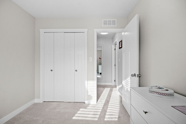 carpeted bedroom with a closet