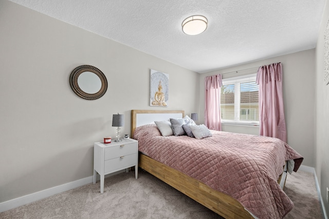 carpeted bedroom with a textured ceiling