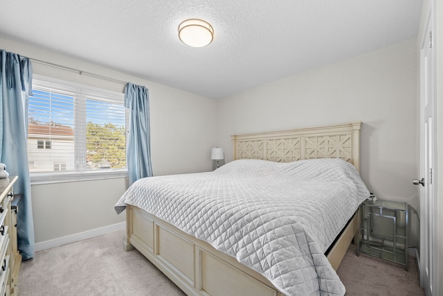 carpeted bedroom featuring a textured ceiling