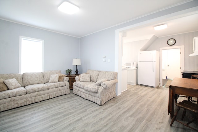 living room featuring light hardwood / wood-style floors and crown molding