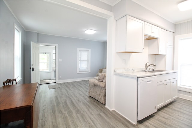 kitchen with white dishwasher, a healthy amount of sunlight, and white cabinets