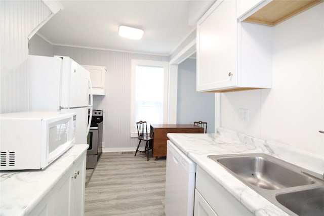 kitchen featuring light wood-type flooring, ornamental molding, white appliances, sink, and white cabinets