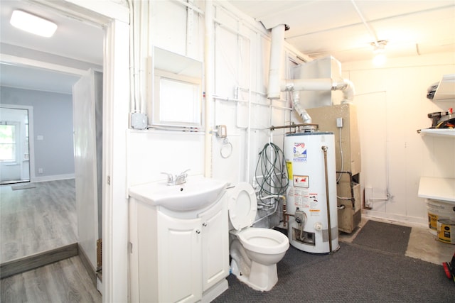 bathroom with vanity, wood-type flooring, gas water heater, and toilet