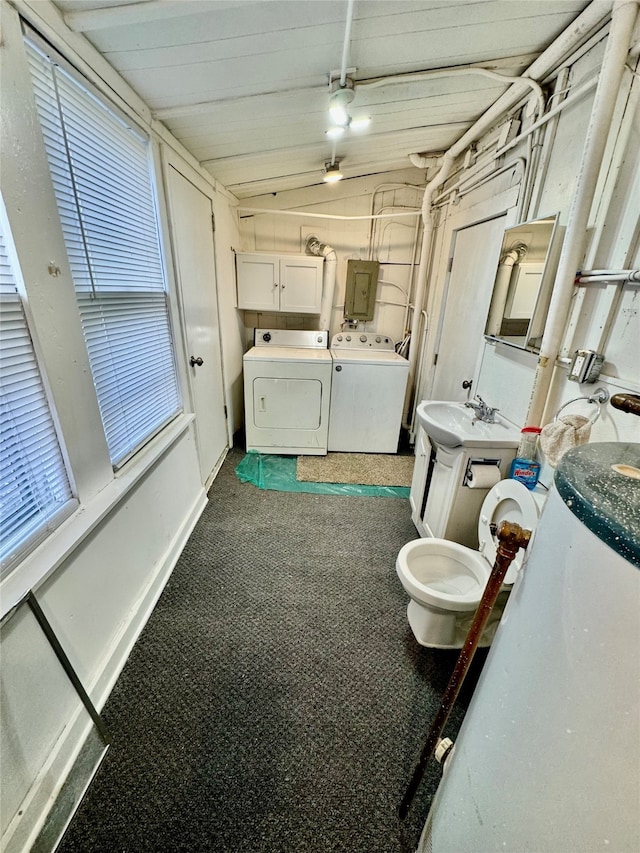 bathroom featuring a healthy amount of sunlight, independent washer and dryer, sink, and electric panel