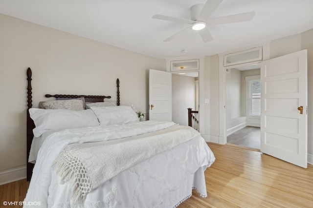 bedroom featuring ceiling fan, wood finished floors, and baseboards