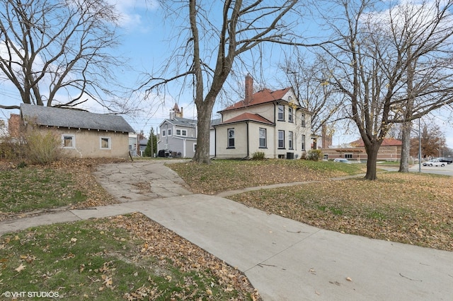 view of home's exterior featuring a chimney and a residential view