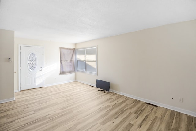 spare room featuring light hardwood / wood-style floors