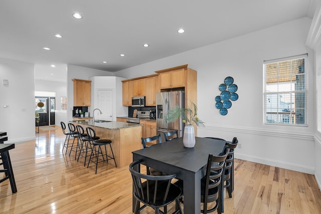 dining room with light hardwood / wood-style flooring and sink