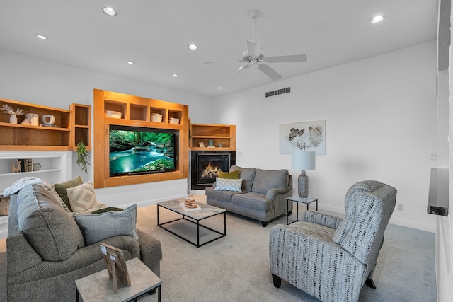 carpeted living room featuring ceiling fan