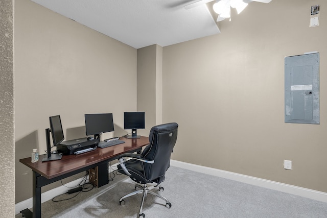 carpeted office space with electric panel and ceiling fan