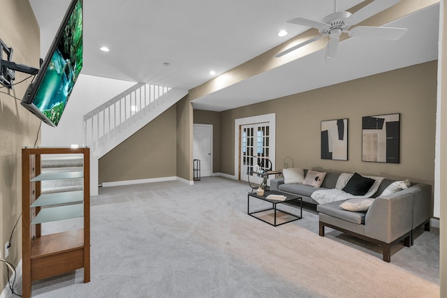 carpeted living room featuring french doors and ceiling fan