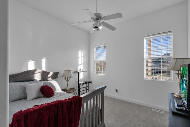 carpeted bedroom with vaulted ceiling and ceiling fan