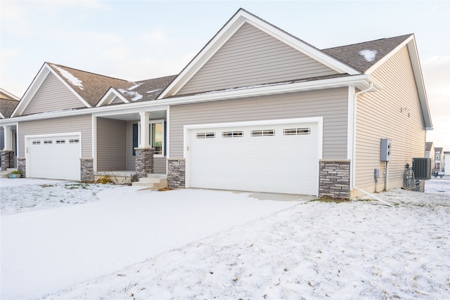 craftsman-style house featuring cooling unit and a garage