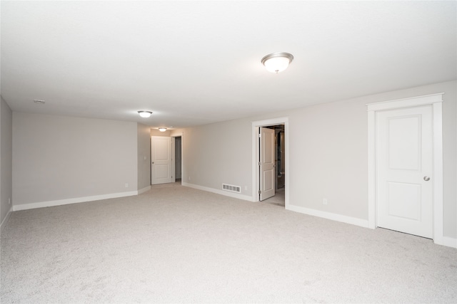 unfurnished room featuring light carpet