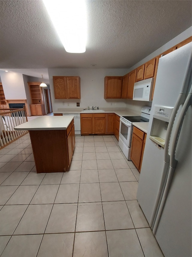 kitchen featuring light tile patterned flooring, sink, white appliances, and a textured ceiling