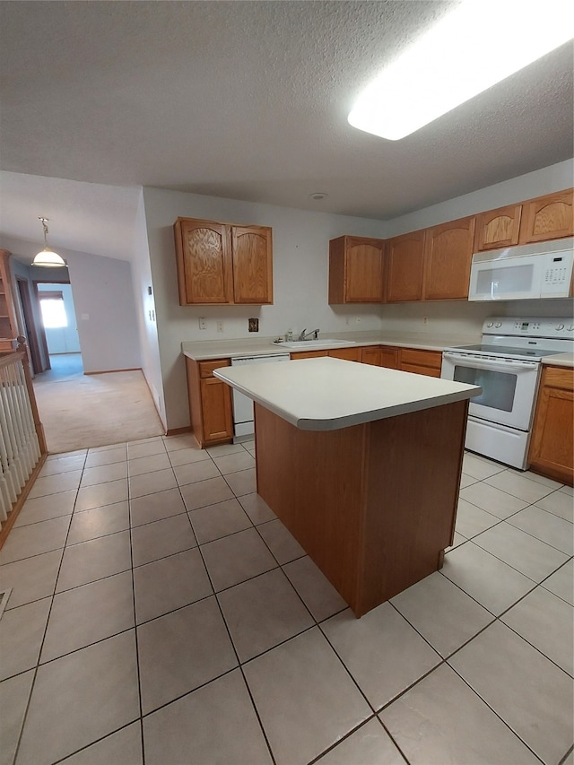 kitchen featuring a center island, white appliances, sink, a textured ceiling, and light tile patterned flooring