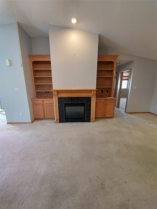 unfurnished living room featuring light colored carpet and lofted ceiling