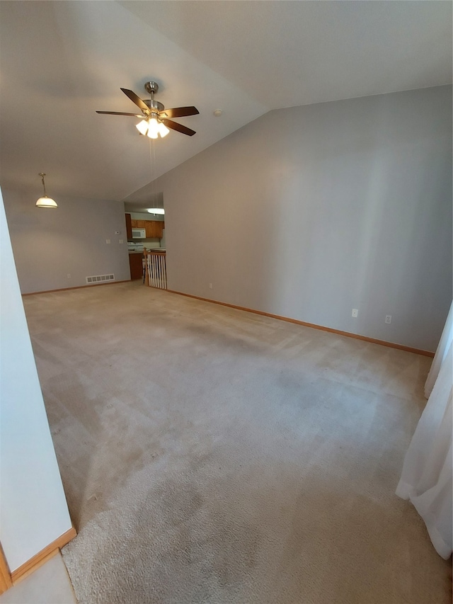 unfurnished living room featuring ceiling fan, light carpet, and vaulted ceiling