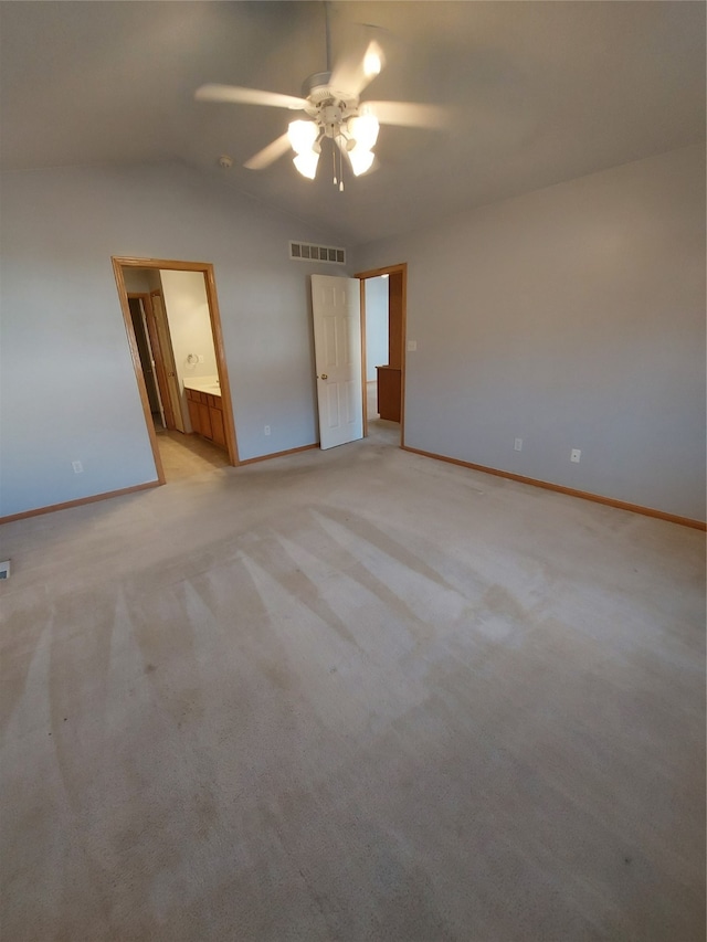 carpeted spare room with ceiling fan and lofted ceiling