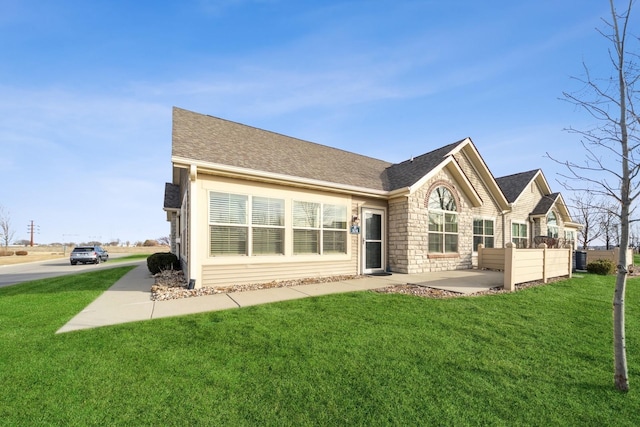 back of house with a yard and a patio area