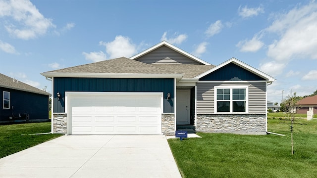 view of front of property with an attached garage, stone siding, concrete driveway, and a front yard