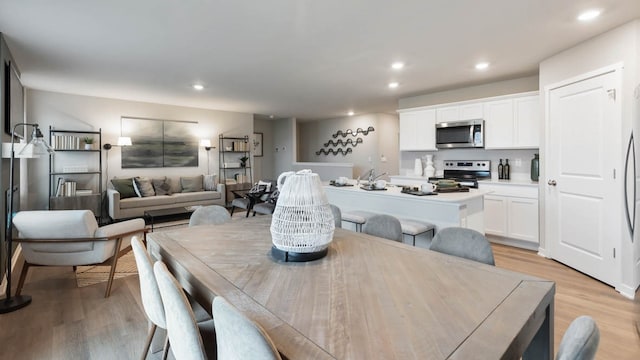 dining space with light hardwood / wood-style flooring