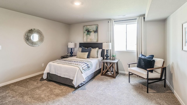 carpeted bedroom with visible vents and baseboards