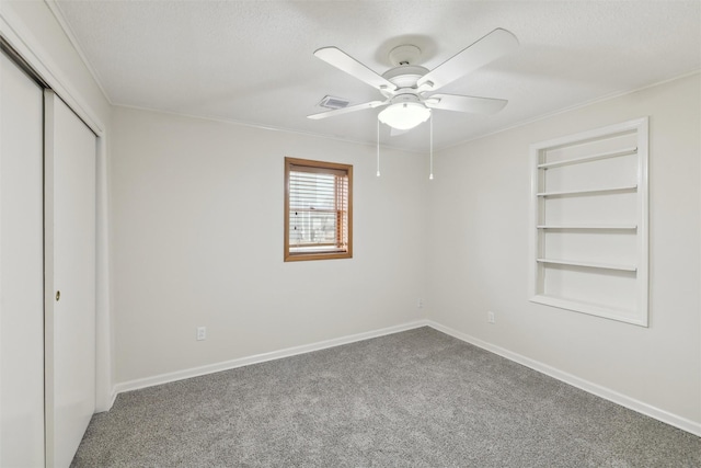 unfurnished bedroom featuring carpet, a closet, and ceiling fan