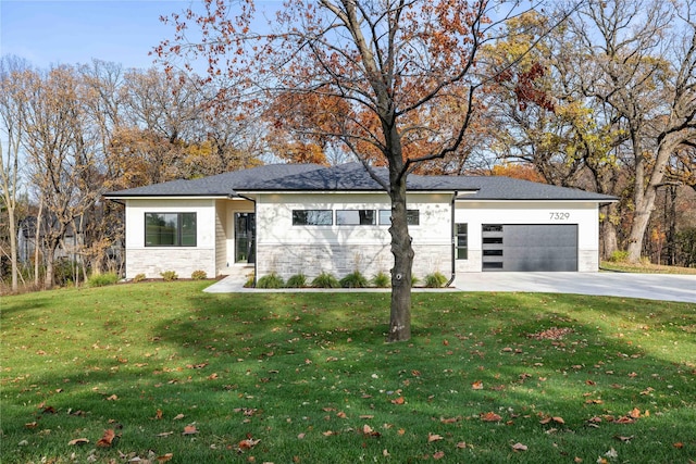 prairie-style house featuring a front yard and a garage