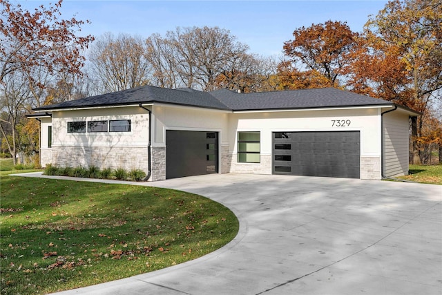 view of front of property featuring a garage and a front yard